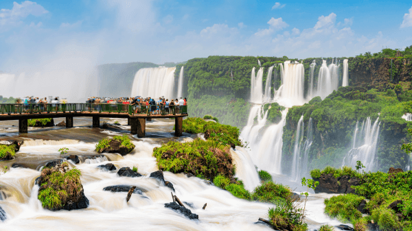 Visitors on an observation deck at Iguazu Falls in Brazil experience the close-up sight and sound of the mighty waterfalls.