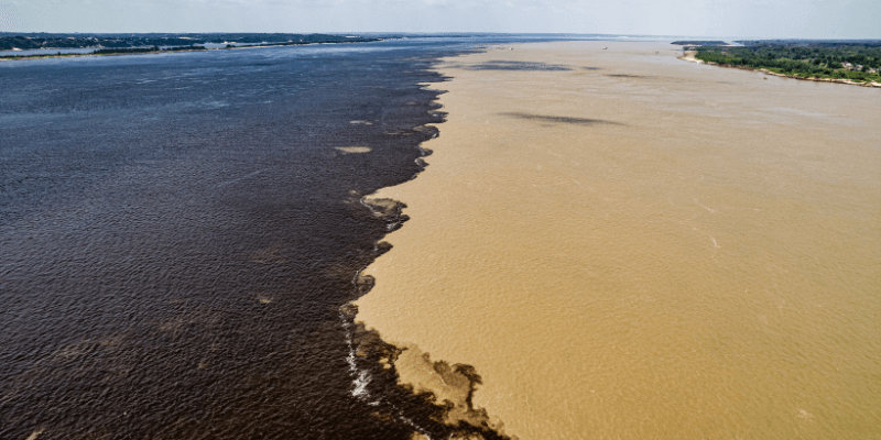 The Meeting of the Waters near Manaus, where the dark Rio Negro and the sandy-colored Amazon River converge but do not mix, creating a striking natural contrast.