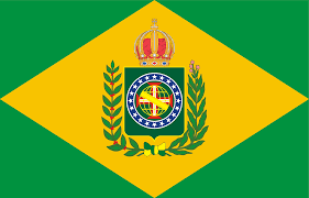 This is an image of the flag of the Empire of Brazil which was in use from 1822 to 1889. The flag features a green field with a yellow rhombus at the center. Inside the rhombus is a blue circle with the imperial coat of arms in the center, surrounded by coffee and tobacco branches, which were crucial crops for Brazil's economy during the imperial period. The coat of arms includes a cross, a sphere, and an imperial crown above.