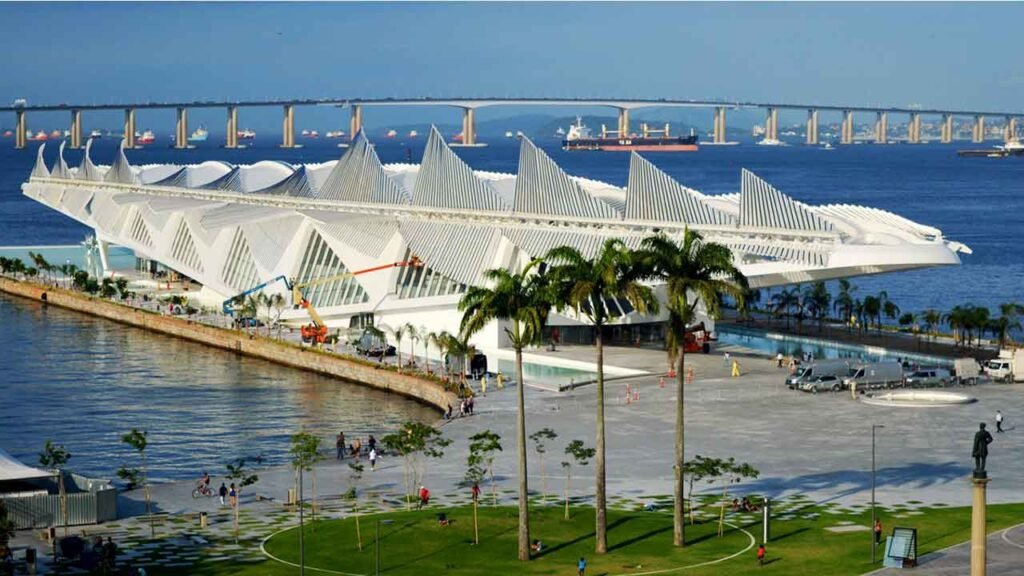 The futuristic Museum of Tomorrow in Rio de Janeiro, featuring striking modern architecture by the bay with a view of the bridge in the background. One of the unique things to do in Rio de Janeiro.